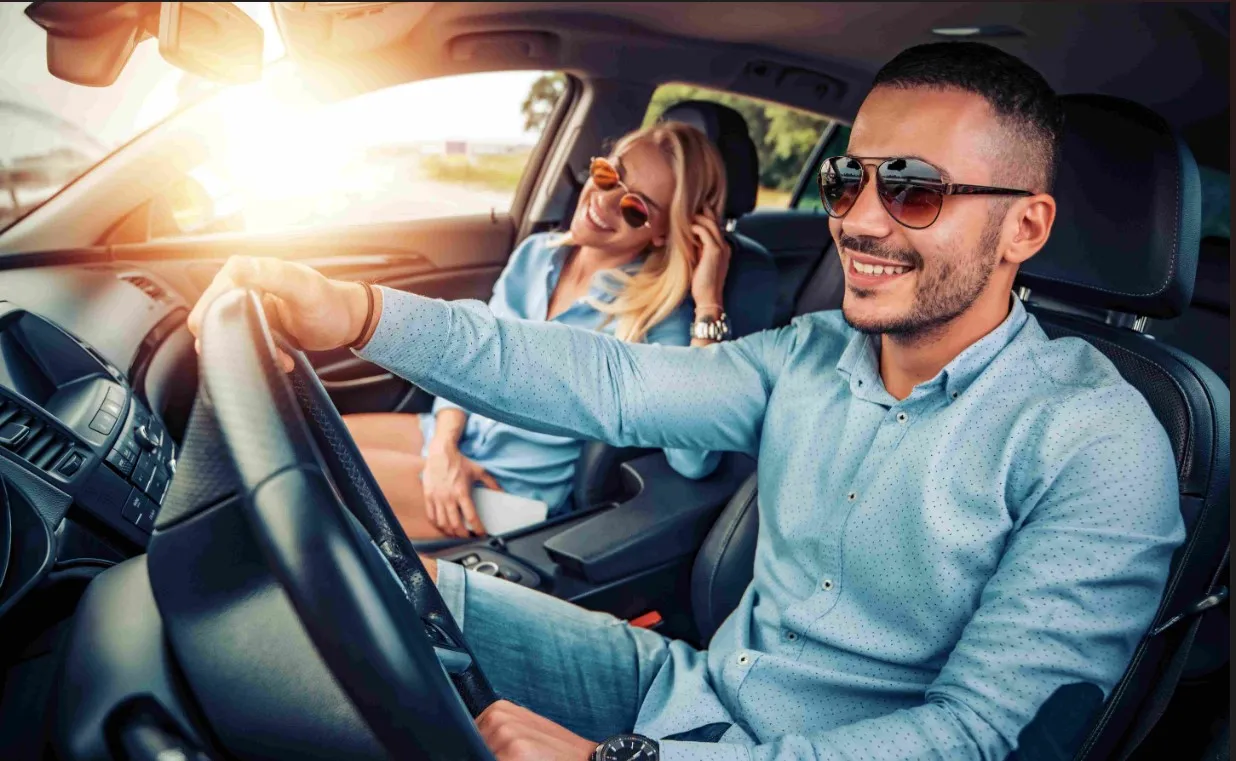 man and woman in hybrid car